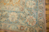 Corner detail of a vintage Tabriz showing the main palmette border in sky blue and a pale rust field.