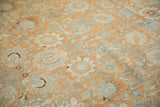 Evenly worn pile of a vintage Tabriz carpet showing terracotta and dusty blue palmettes.