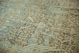 Intricate faded vine pattern and visible abrash on a distressed vintage Tabriz rug.