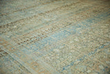 Distressed Tabriz carpet with muted powder blue, terracotta, and ivory abrash patterns.