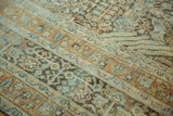 Intricate faded blue, rust, green floral motifs with abrash and even wear to foundation.