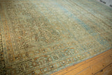 Intricate border on a distressed vintage Tabriz rug, with abrash, powder blue, and terracotta.
