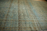 Distressed border of vintage Tabriz carpet, with faded terracotta cartouches and powder blue floral details.