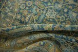 Distressed vintage Tabriz rug with abrash, powder blue, green, and terracotta floral motifs.