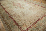 Distressed cochineal red Safavid-inspired border with faded floral patterns on a Kerman carpet.