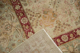 View of the Kerman carpet's textured distressed pile, revealing its hand-knotted foundation and secured edge.