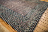Antique Serbend rug border with intricate navy and ivory motifs, worn aubergine field.