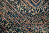 Distressed texture of antique Serbend carpet, revealing faded navy and blush boteh motifs.