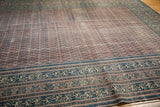 Worn Persian Serbend border with intricate faded navy, blush, and ivory patterns.