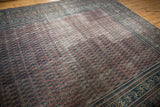 Distressed Serbend rug's boteh motifs with germinating plants in faded aubergine, showing foundation wear.