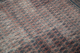 Distressed antique Serbend rug, showing faded aubergine and navy boteh with visible foundation.