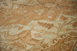 Close-up showing the soft, low pile and intricate vine motifs of a distressed Heriz carpet.