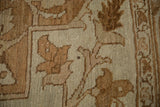 Close-up of the distressed, hand-knotted texture showing botanical motifs in soft earthy tones.