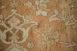 Distressed low pile of a vintage Heriz carpet with soft sand and ivory botanical details.