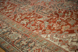 Low pile texture and geometric samovar designs on a distressed vintage Persian Heriz carpet.