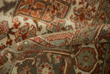 The even, low-pile texture of a distressed Heriz carpet seen in a softly rolled view.
