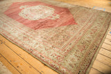 Faded Herati and turtle samovar border with even wear on an antique distressed Bijar rug.