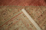 Antique distressed Bijar carpet: folded corner reveals hand-knotted foundation, selvage, and worn pile.