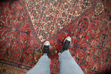 Antique Persian Mahal carpet with brick red field, sapphire blossoms, tendrils, and mostly even wear.