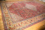 Herati floral border with sand ground and brick red field on this antique Mahal carpet.