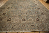 Vintage distressed Tabriz carpet: slate blue and beige floral motifs, with even wear to knot heads.