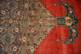 A bat-shaped finial and stepped corner spandrel with Herati motif on an antique Bijar carpet.