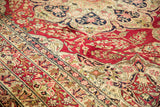 Close-up of the signature cartouche within the main floral border of an antique Kerman rug.
