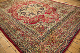 Fine antique Kerman carpet's starburst medallion and detailed border viewed from a corner perspective.