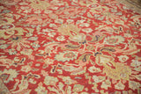 Angled view showing the low-pile texture and floral bouquets on a distressed Mahal carpet.