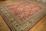 Large-scale saffron Herati border frames the distressed cherry red floral field of a vintage Mahal.