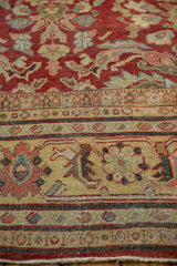 Angled close-up of the saffron yellow Herati main border on a distressed vintage Mahal carpet.