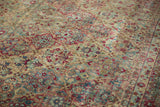 Time-softened tones of raspberry red and sky blue across the low pile of a vintage Kerman carpet.