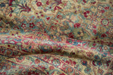 Detailed texture of a distressed Kerman carpet showing worn knot heads among floral patterns.