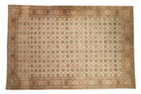 Distressed vintage Qom carpet with an allover floral design in earthy terracotta, sand, and dusty blue.