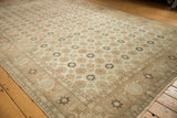 Detailed view of the Turtle Samovar border and allover floral field of a distressed Persian Qom rug.