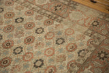 The worn pile of a vintage Qom showing the terracotta Turtle Samovar border and floral field.