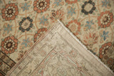 A folded corner of the distressed vintage Qom carpet reveals the hand-knotted foundation and side cord.