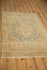 Distressed Vintage Sarouk rug corner with faded floral border and light foundation wear.
