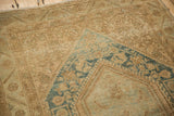Close-up of distressed Sarouk rug: mostly even wear to knot heads, faded beige and blue floral.