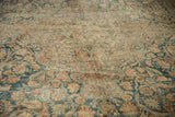 Floral arabesques and mostly even wear on this distressed vintage Kerman carpet.