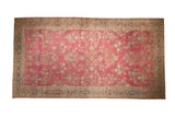 Antique Persian Lilihan carpet with a distressed allover floral design in teal and sand on a raspberry red field.
