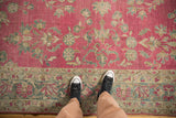 Even wear to the knot heads on a distressed Lilihan carpet with magenta and teal floral bouquets.