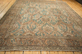 Distressed Sparta rug border with faded sandalwood, dusty teal stylized floral motifs.