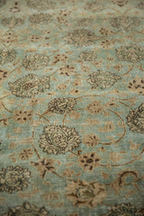 Angled view of the distressed pile showing outlined florals and spiraling vines on a Meshed carpet.