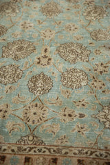 Worn texture of a distressed Persian Meshed carpet with foundation showing through the pile.