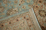 Corner detail of a vintage distressed rug showing the sturdy machine-bound edge and low pile.