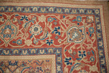 Corner detail of a Northwest Persian carpet showing the Turtle Samovar border and red Herati field.