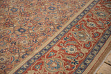 Angled view of the camel Herati field and wide red Turtle Samovar border on a Persian carpet.