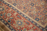The antique carpet's cherry red Turtle Samovar border contrasts with the camel Herati field.