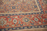 Corner detail of an antique Persian carpet's camel Herati field and red Turtle Samovar border.